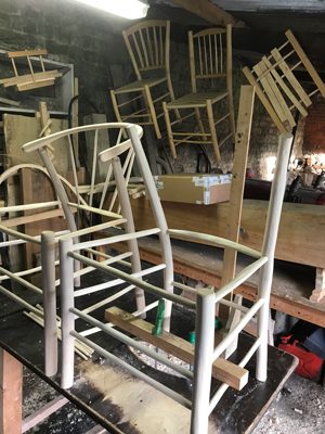 incomplete Swoop style chair frames on the workbench at the Rustic Ash Chairs workshop